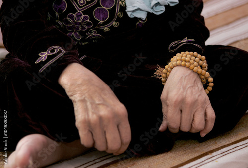 An elderly lady's hands and a wound wrapped around her in her room at a nursing home.