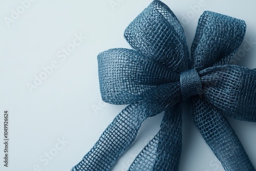 A detailed image of a large blue mesh bow, displaying intricate fabric texture that adds elegance and beauty, perfect for gift wrapping or decoration. photo