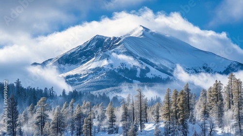 Snow-covered mountains with a serene lake in the foreground, surrounded by a winter forest and a clear sky, capturing the beauty of nature in a scenic alpine landscapesnow covered mountains photo