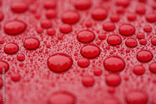 Closeup waterdrops on red ceramic coated paint surface