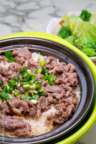 angle view clay pot rice with beef and lettuce at vertical composition