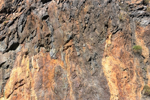 gray red yellow rock face close-up, mountain in nature photo