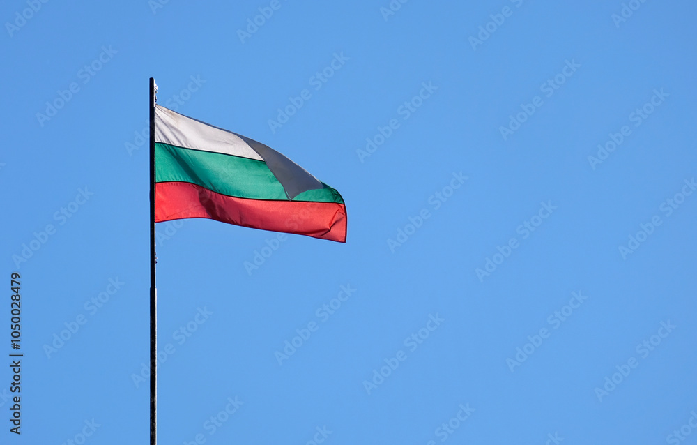 The national flag of Bulgaria in the wind against a blue sky The national flag of Bulgaria in the wind against a blue sky