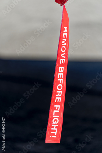 75 year anniversary of Swiss Zürich Kloten Airport with close-up of remove before flight tag on a sunny summer day. Photo taken September 1st, 2023, Kloten, Canton Zürich, Switzerland. photo