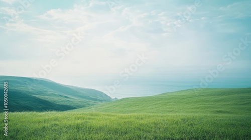 In this picturesque rural scene, we observe vibrant lush green fields stretching out, and a serene calm water body glistening splendidly under an inviting clear and bright blue sky above