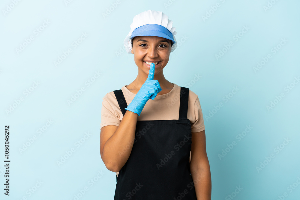 Fishwife asian woman over isolated background showing a sign of silence gesture putting finger in mouth Fishwife asian woman over isolated background showing a sign of silence gesture putting finger in mouth