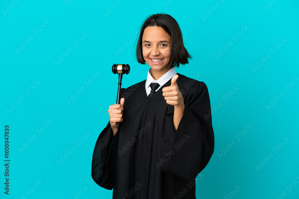 Judge over isolated blue background with thumbs up because something good has happened Judge over isolated blue background with thumbs up because something good has happened
