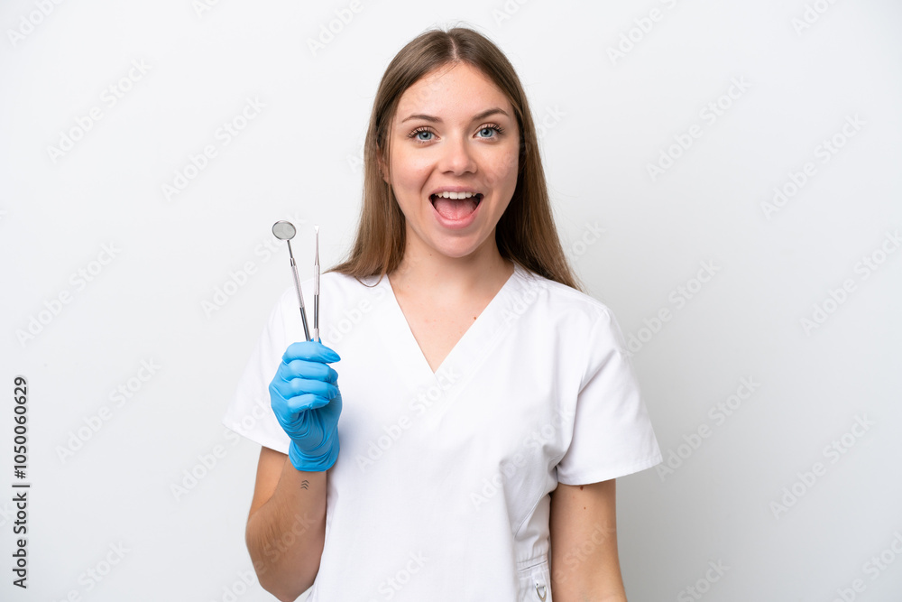 Dentist woman holding tools isolated on white background with surprise facial expression Dentist woman holding tools isolated on white background with surprise facial expression