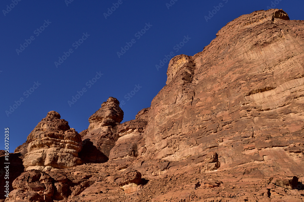 A series of red stone monoliths against a clear blue skry in Al Ula Saudi Arabia A series of red stone monoliths against a clear blue skry in Al Ula Saudi Arabia