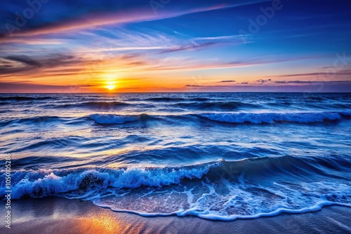 Dark blue ocean waves gently lapping against the shore at sunset, soothing colors, wave motion, calm sea, ocean breeze photo