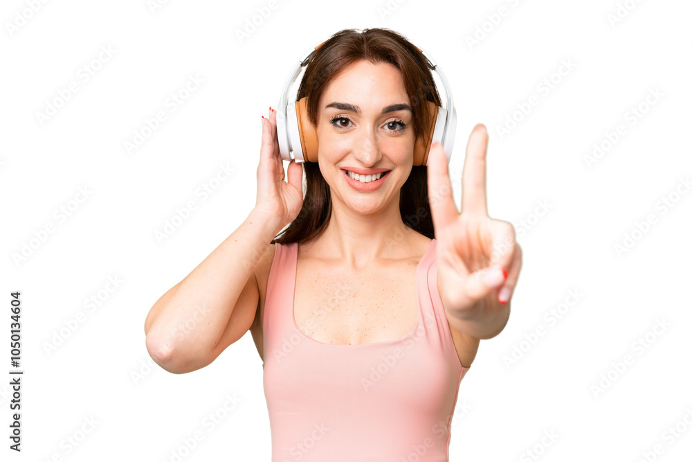 Young caucasian woman over isolated chroma key background listening music and singing Young caucasian woman over isolated chroma key background listening music and singing