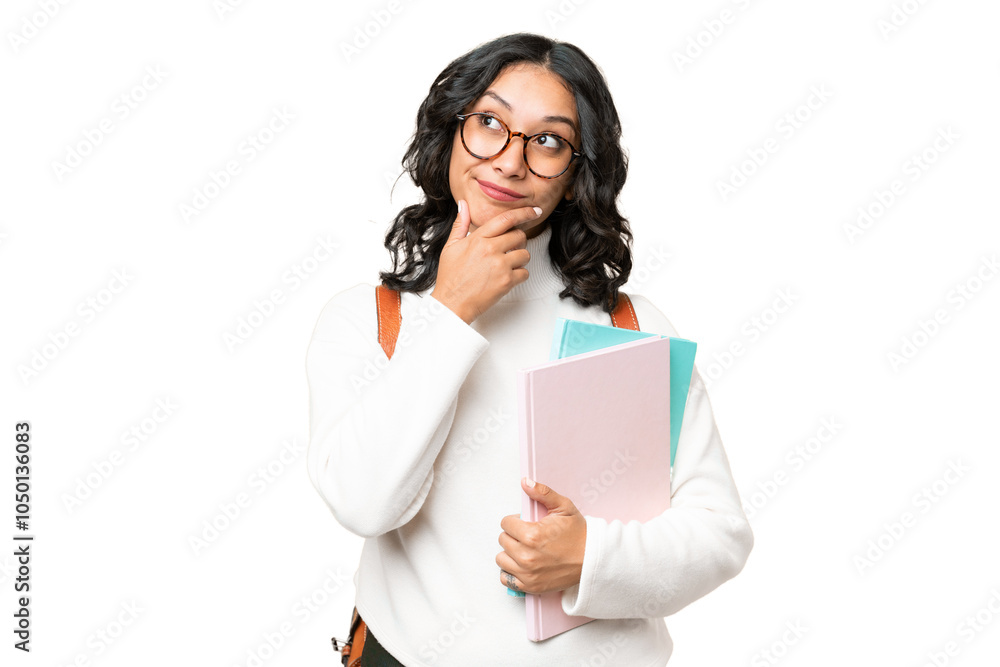 Young Argentinian student woman over isolated background and looking up Young Argentinian student woman over isolated background and looking up