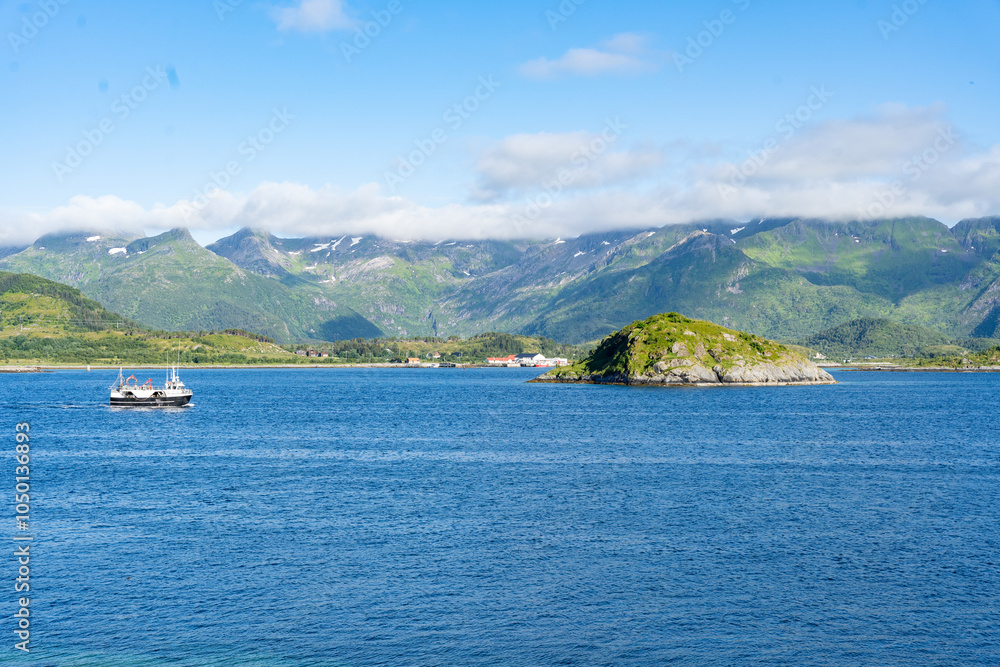 Obraz premium Landscape of small ship in Gimsoystraumen strait in the Lofoten islands, Norway