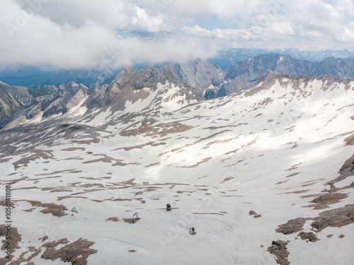 Quadro su tela A breathtaking view of a mountainous snowy landscape under a cloudy sky