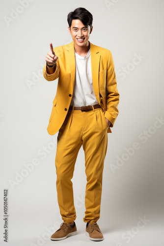 a man in yellow color formal outfit standing in the studio with isolated background
