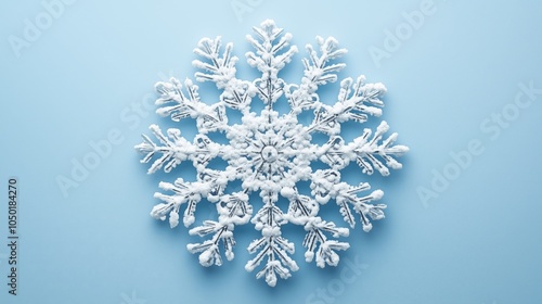 A single snowflake glistens, showcasing its intricate patterns and delicate design