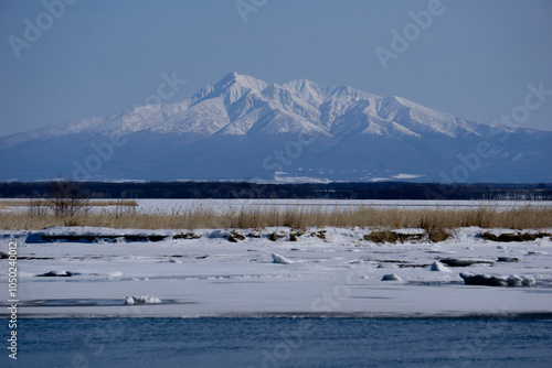 snow covered mountains with ocean