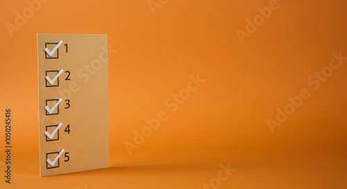 Checklist with numbered items on orange background photo