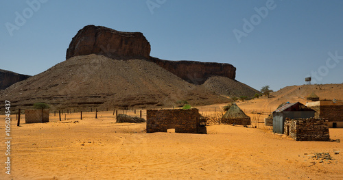 West Africa. Mauritania. Buildings made of sand and stone in a village in the south of the Sahara Desert near the Terjit oasis. photo