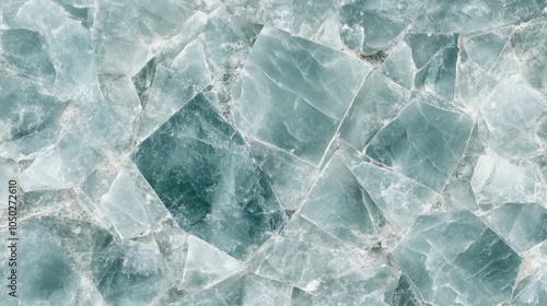 Mosaic-like abstract background with sharp triangular shapes in varying shades of blue and green.