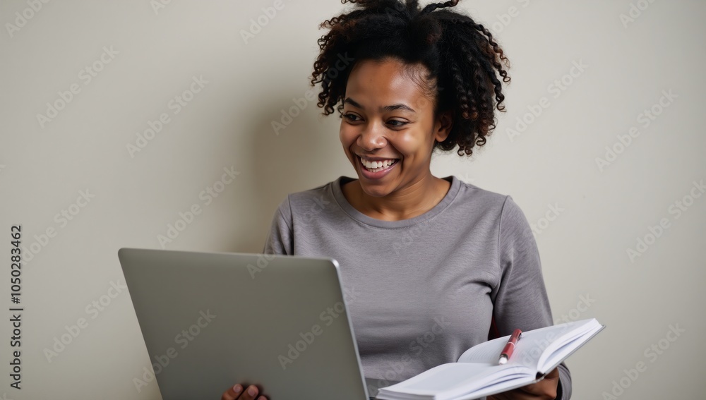 An empowered African-American student engaged in remote learning studying diligently while taking notes An empowered African-American student engaged in remote learning studying diligently while taking notes