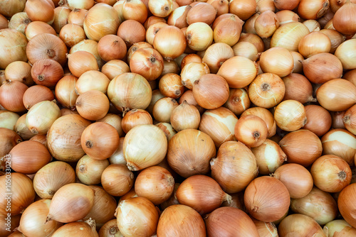 Pile of onions on outdoor market stall. São Paulo city, Brazil