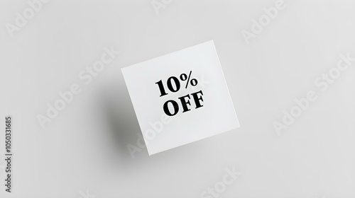 Black '10% OFF' Text on a White Square Paper Note. White Background with Copy Space