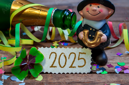 Wooden hang tag and slate with four leaf clover and sparklers with the german words for happy new year - frohes neues jahr 2025 on wooden weathered background photo