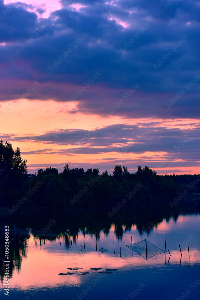 The sunset background creates a beautiful scenery with the suspension bridge and river The sunset background creates a beautiful scenery with the suspension bridge and river