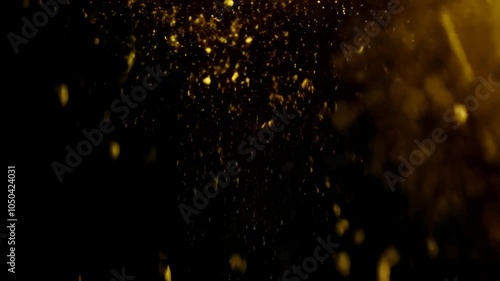 Soft Falling Golden Particles Creating a Magical, Elegant Atmosphere on Black