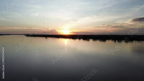 Wallpaper Mural Drone View Sunset reflecting over a calm lake and river with orange skies and clouds Torontodigital.ca