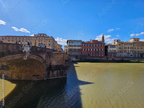 Florence, Italy - October 5, 2024: Discovering the city of Florence in autumn days. Frome the Duomo to Ponte Vecchio, old architecture covering the city. Beautiful sky reflected over Arno river.
