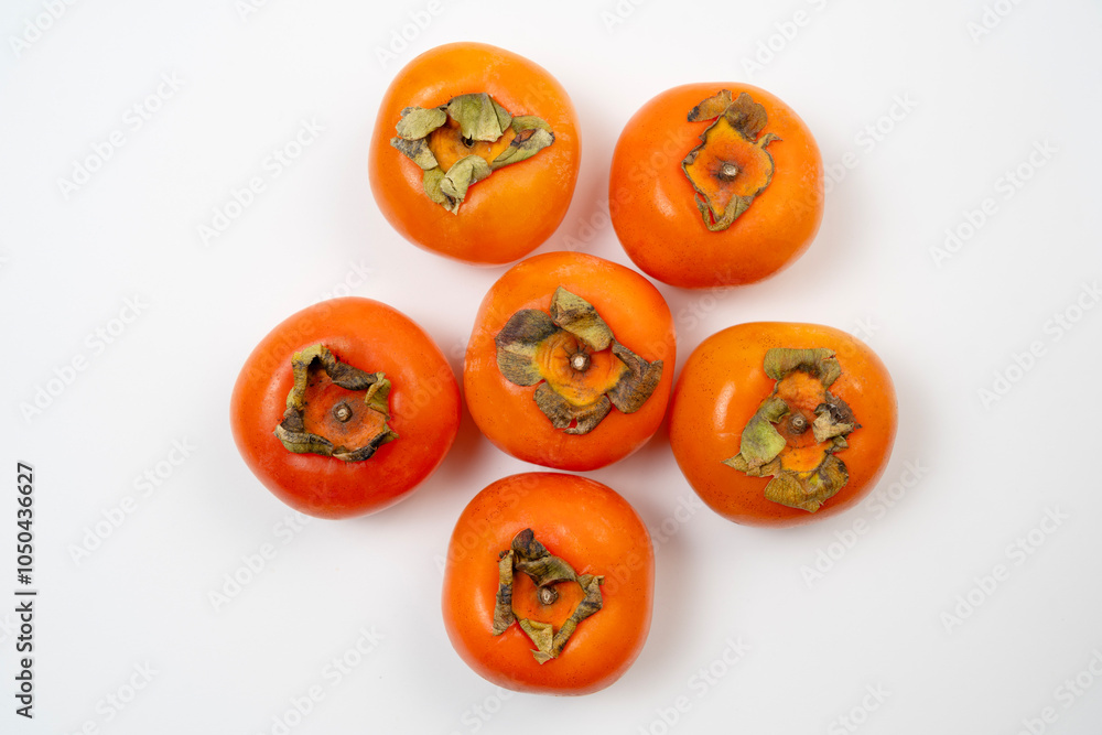 Persimmons are sweet, orange fruits commonly enjoyed in autumn Persimmons are sweet, orange fruits commonly enjoyed in autumn