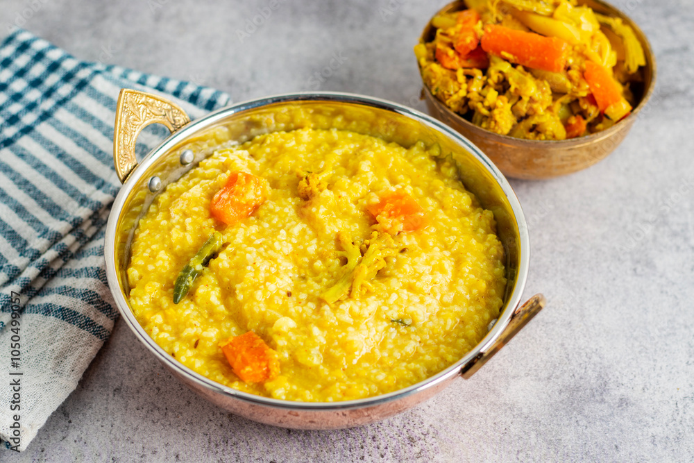 Khichdi is a comforting Indian dish made with rice, lentils, and mild spices, often served as a nourishing, easy-to-digest meal. Khichdi is a comforting Indian dish made with rice, lentils, and mild spices, often served as a nourishing, easy-to-digest meal.