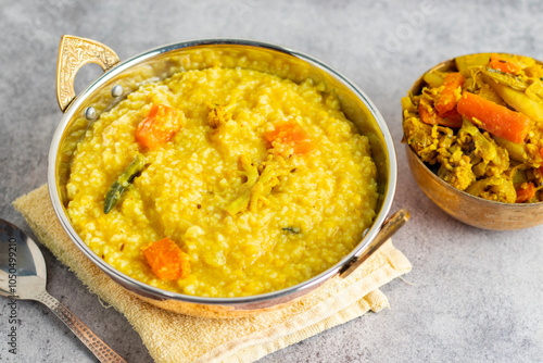 Khichdi is a comforting Indian dish made with rice, lentils, and mild spices, often served as a nourishing, easy-to-digest meal.