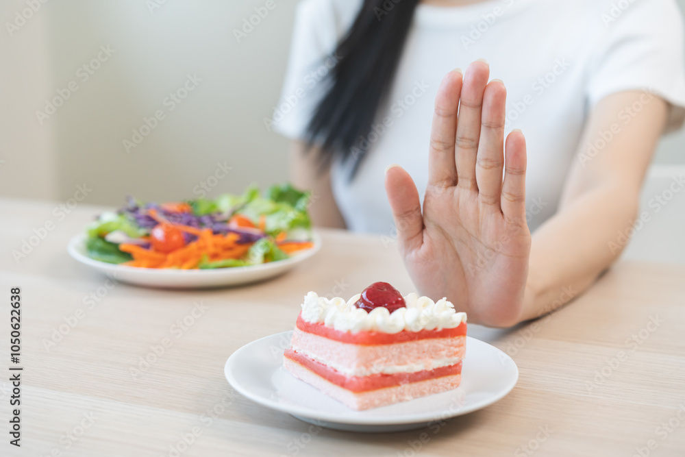 Diet asian young woman, girl hand push out, refuse eat piece strawberry cake, sweet or dessert taste, choose eat salad, fighting to keep it from getting fat. Fast food unhealthy of weight loss concept Diet asian young woman, girl hand push out, refuse eat piece strawberry cake, sweet or dessert taste, choose eat salad, fighting to keep it from getting fat. Fast food unhealthy of weight loss concept