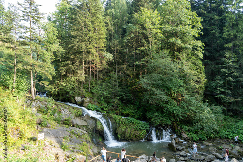 Mountain waterfall in the forest. Green nature. Lake water Kamianka in the Ukrainian Carpathians river photo