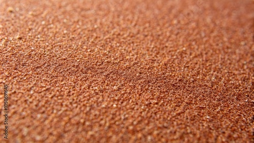 Close-up of a sandpaper surface, displaying its coarse texture and grit, ideal for showcasing woodworking and crafting materials, perfect for DIY projects and industrial design themes. photo