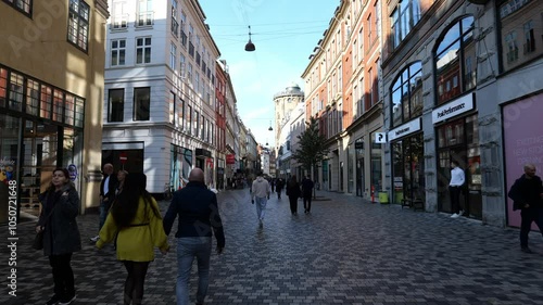 Many people in the city near old buildings with large windows. Copenhagen, DENMARK. OCTOBER 20, 2024