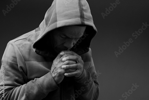 man praying to god with hands together Caribbean man praying on black background with people stock photos stock photo stock image 