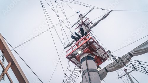 A white and red ship mast in close view photo