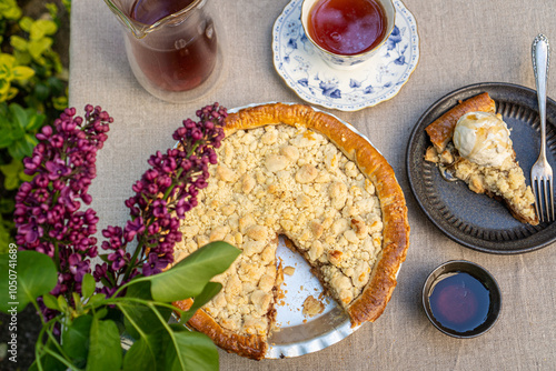 Apple crumble pie with ice cream and tea on a floral table photo