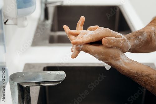 Selective focus on the doctor, before the operation that  cleaning and desinfection his hands with the soap photo