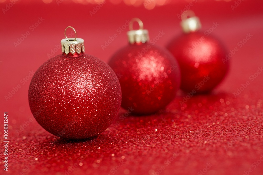 Three shiny red Christmas ornaments on a vibrant red background, conveying festive holiday spirit. Three shiny red Christmas ornaments on a vibrant red background, conveying festive holiday spirit.