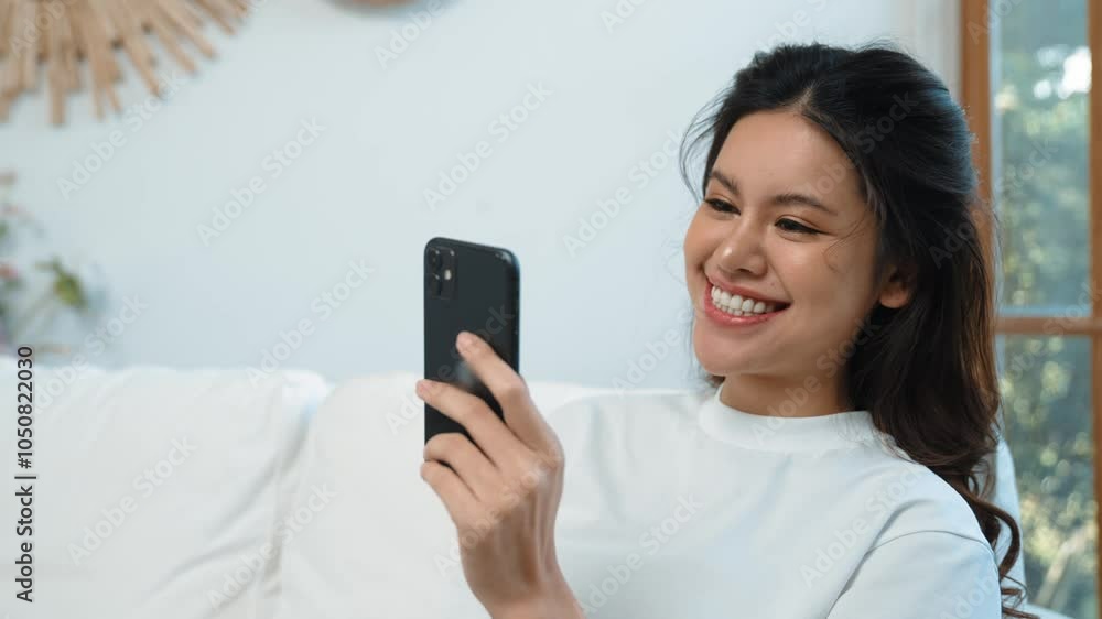 Young woman using smartphone browsing for online shopping E commerce by online payment gateway at vivancy home. Modern and convenience online purchasing make secure and convenient purchases. Young woman using smartphone browsing for online shopping E commerce by online payment gateway at vivancy home. Modern and convenience online purchasing make secure and convenient purchases.