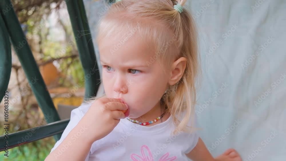 Cute little child girl is eating carrots outdoor. Cute little child girl is eating carrots outdoor.