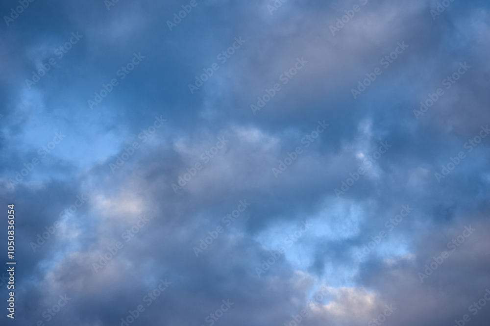Cumulus clouds, white and gray filled the sky, only in places the heavenly blue is visible, a beautiful landscape of the sky Cumulus clouds, white and gray filled the sky, only in places the heavenly blue is visible, a beautiful landscape of the sky