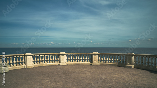 Beautiful view of the Gulf of Finland of the Baltic Sea, the sky with feathery clouds, light ripples on the surface of the water, the observation deck is fenced with an ancient marble fence