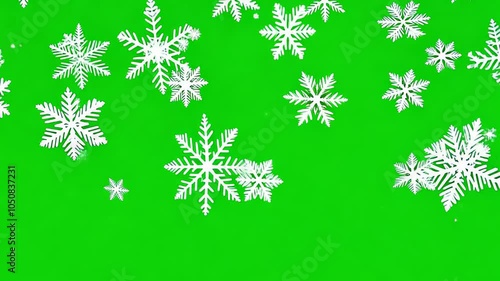 Various snowflakes of different shapes falling on a green background in winter. video
