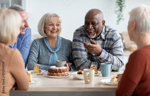Photography International group of positive men and women sitting around table drinking tea